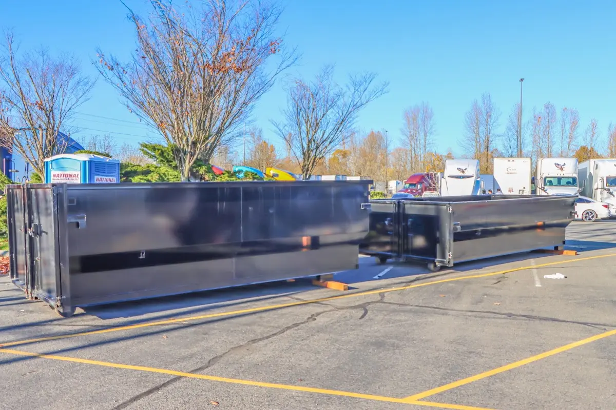 Professional dumpster rental service with roll-off container on residential driveway in Fruitville